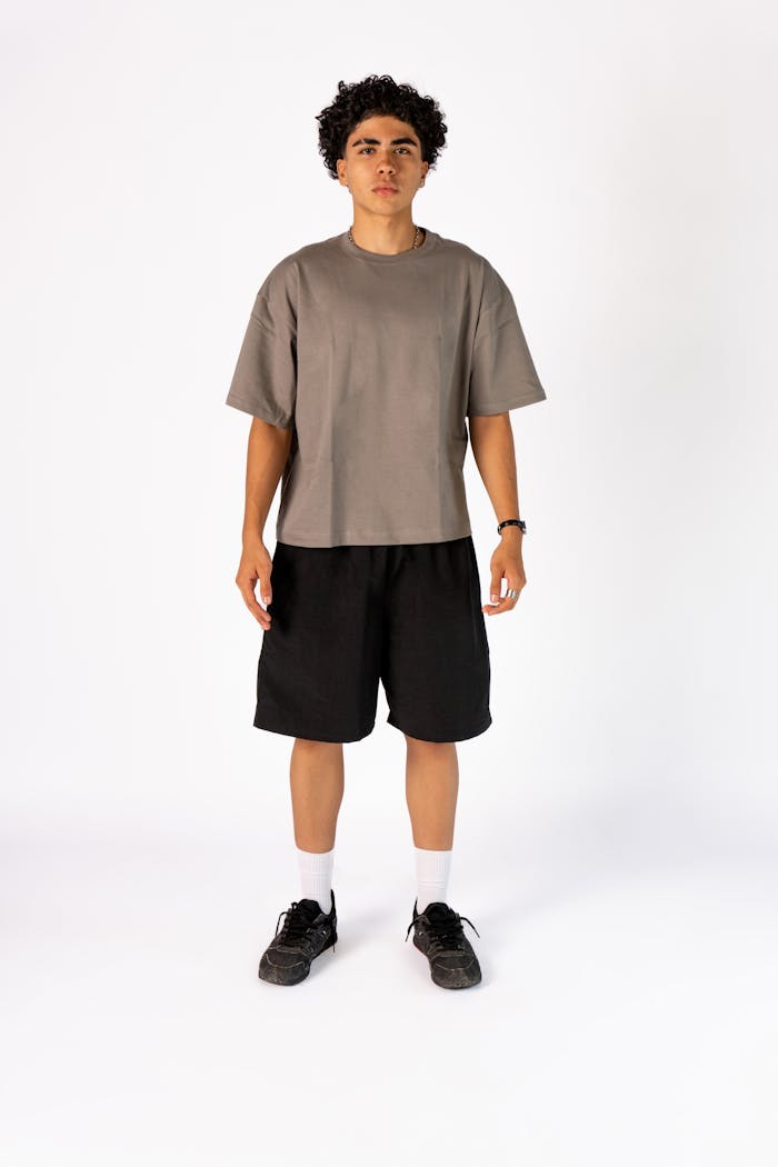 Portrait of a young man wearing casual attire posing against a plain white background.